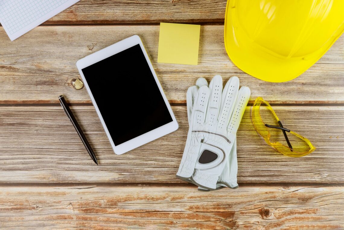 Architect engineer workplace standard construction safety equipment on gloves yellow helmet and