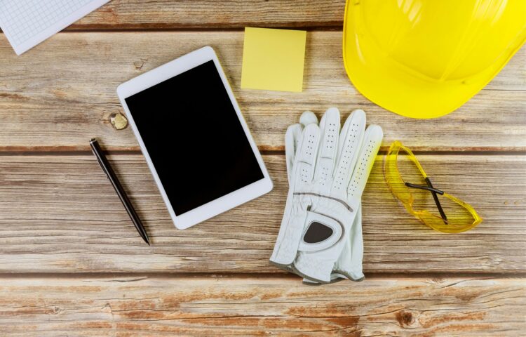 Architect engineer workplace standard construction safety equipment on gloves yellow helmet and