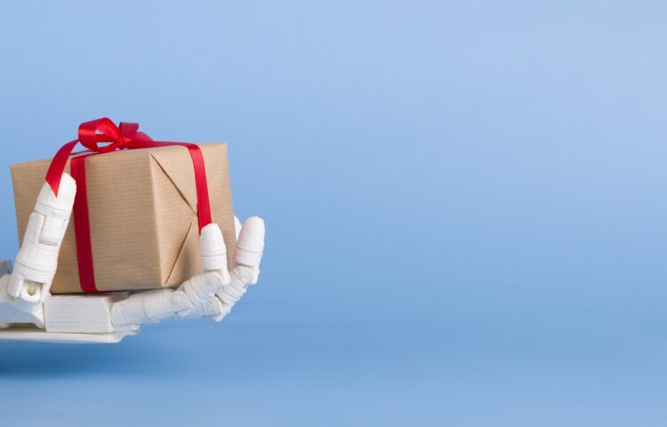 Gift box in automated robot hand, blue background