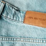 Jeans labeled 100% recycled. Sustainable fashion, conscious consumption.