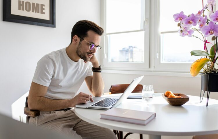 Man working at home using laptop.