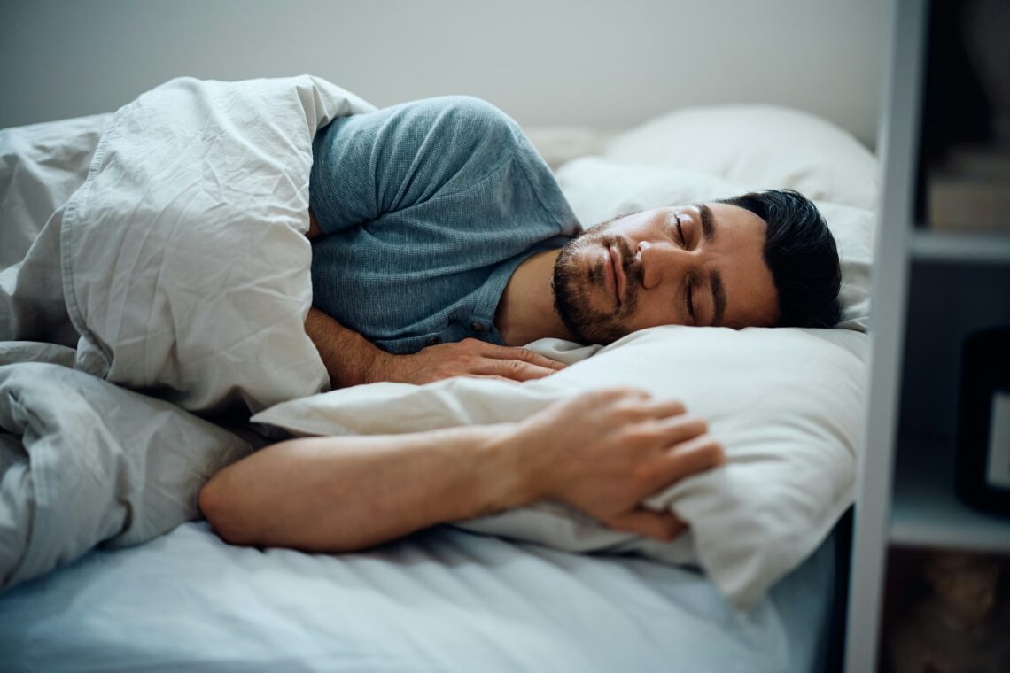 Peaceful man sleeping in the bedroom.