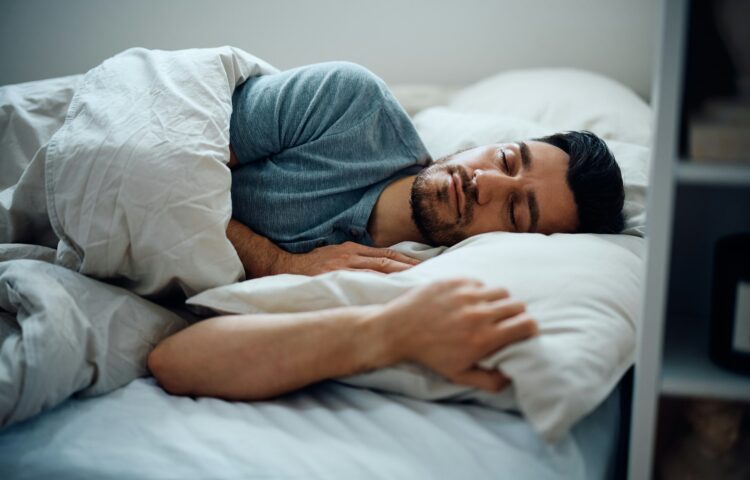 Peaceful man sleeping in the bedroom.