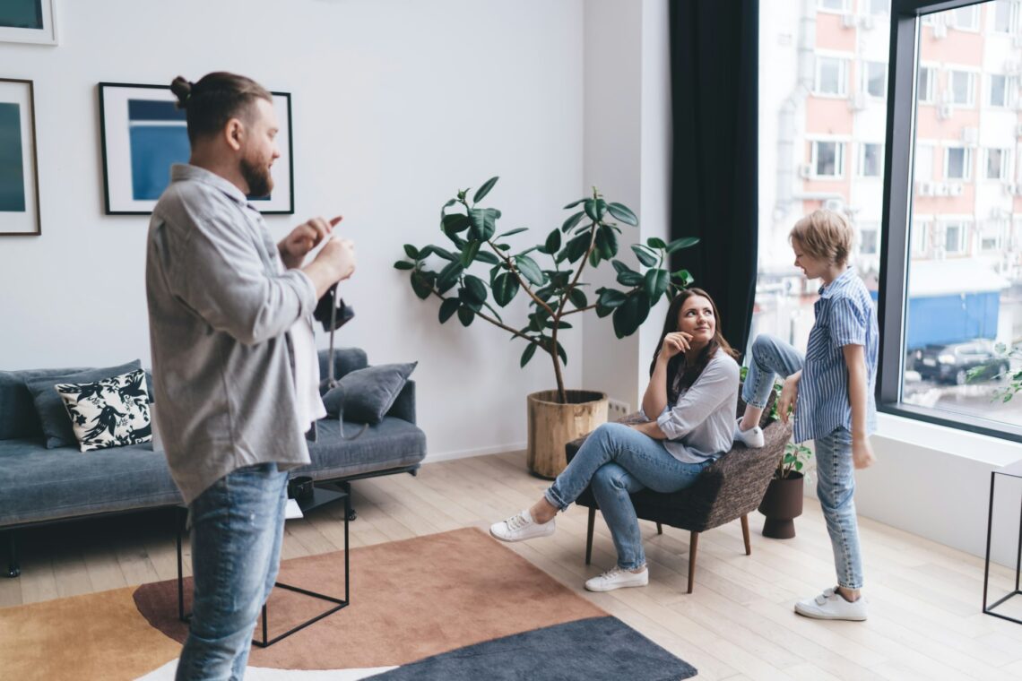 Positive man with camera in living room