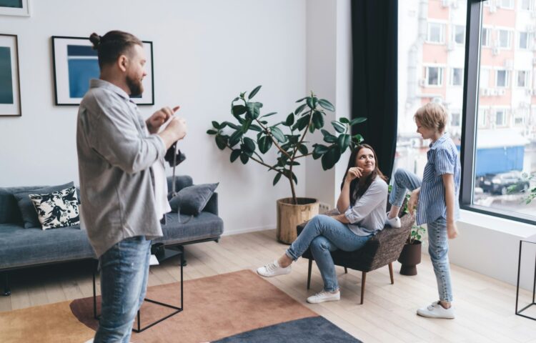 Positive man with camera in living room