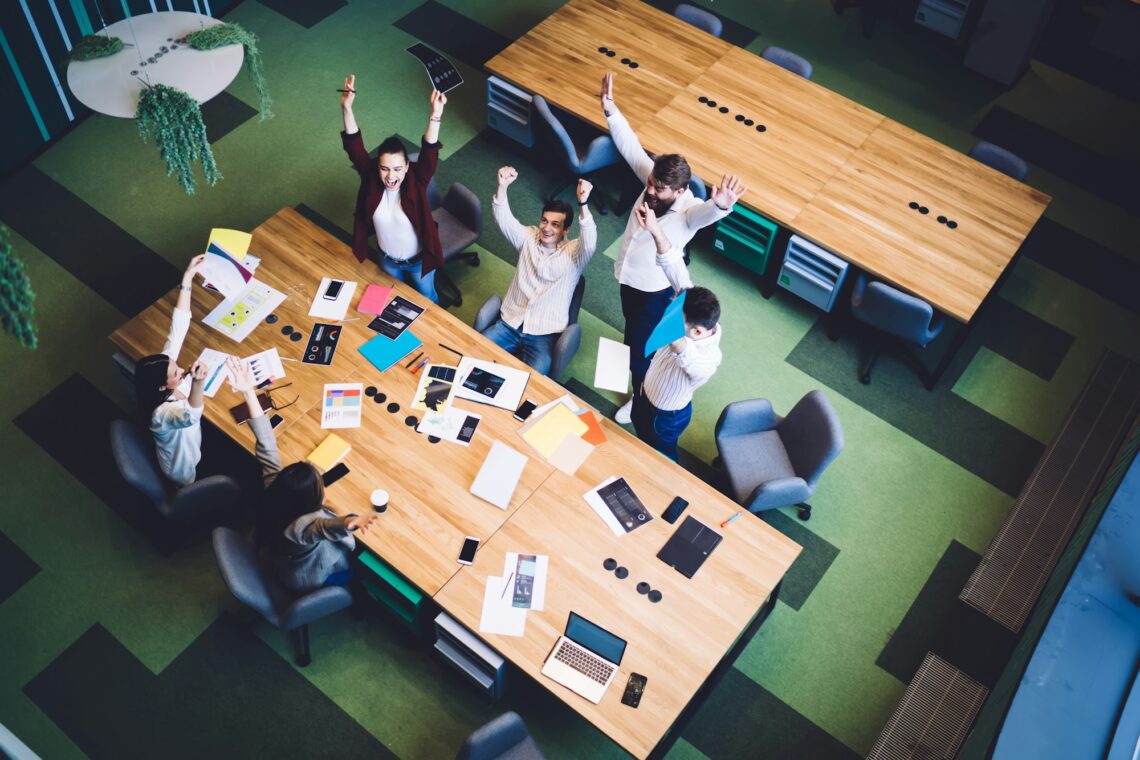 Successful coworkers celebrating news in conference room