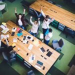 Successful coworkers celebrating news in conference room