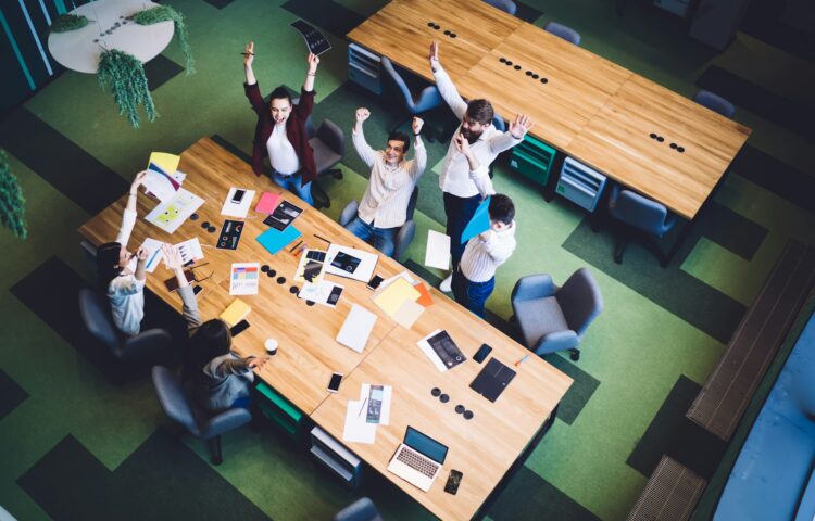 Successful coworkers celebrating news in conference room