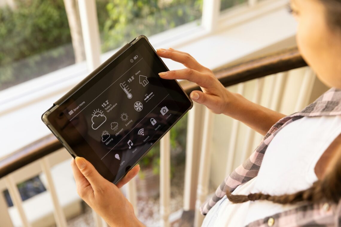 Using tablet, woman controlling smart home system with various settings