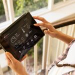 Using tablet, woman controlling smart home system with various settings