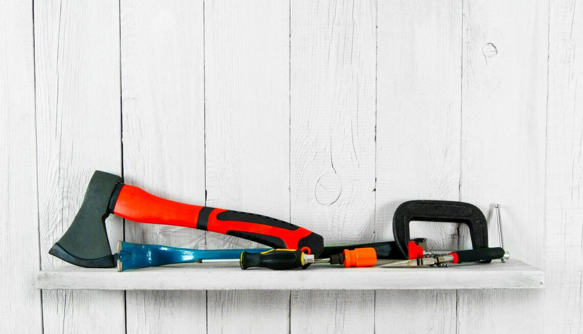 Working tools on wooden shelf.