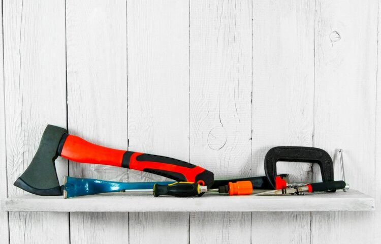 Working tools on wooden shelf.