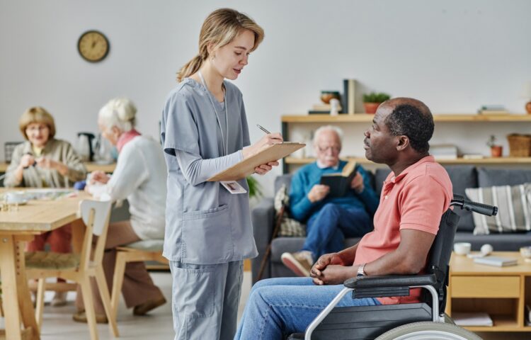 Caregiver talking to man with disability