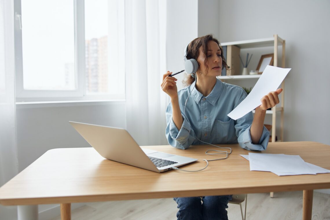 Concentrated self-confident adorable curly businesswoman leader talking with colleagues at online