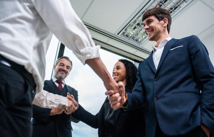 Caucasian businessman making a handshake together while stand in office.