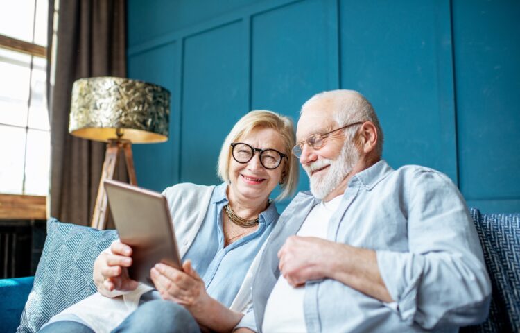 Senior couple with tablet at home