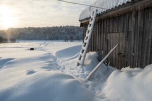Wonderful winter rural landscape. Old wooden barn