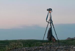 Camera set up on a tripod in an open field