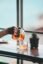 Pouring tea into a glass cup by a window