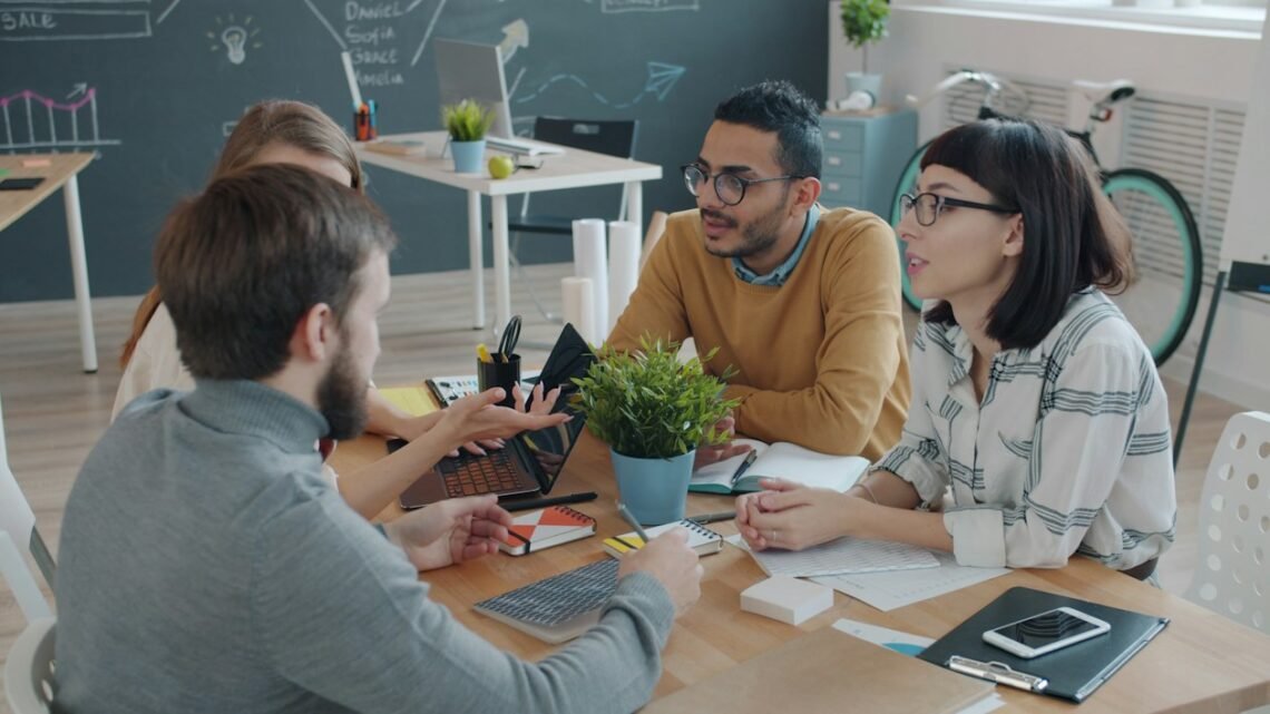Diverse team collaborating around a table in an office