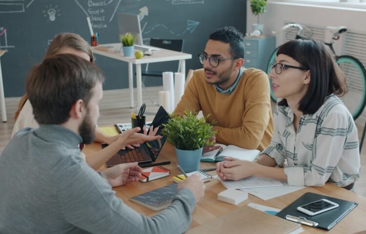 Diverse team collaborating around a table in an office