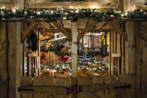 Rustic wooden market stall decorated with festive lights on a winter evening