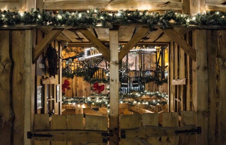 Rustic wooden market stall decorated with festive lights on a winter evening