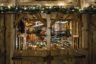 Rustic wooden market stall decorated with festive lights on a winter evening