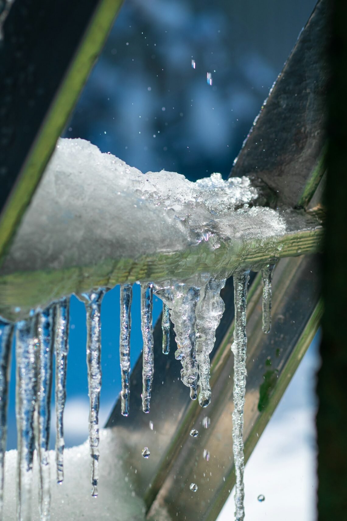 Icicles hanging from a roof gutter in freezing weather