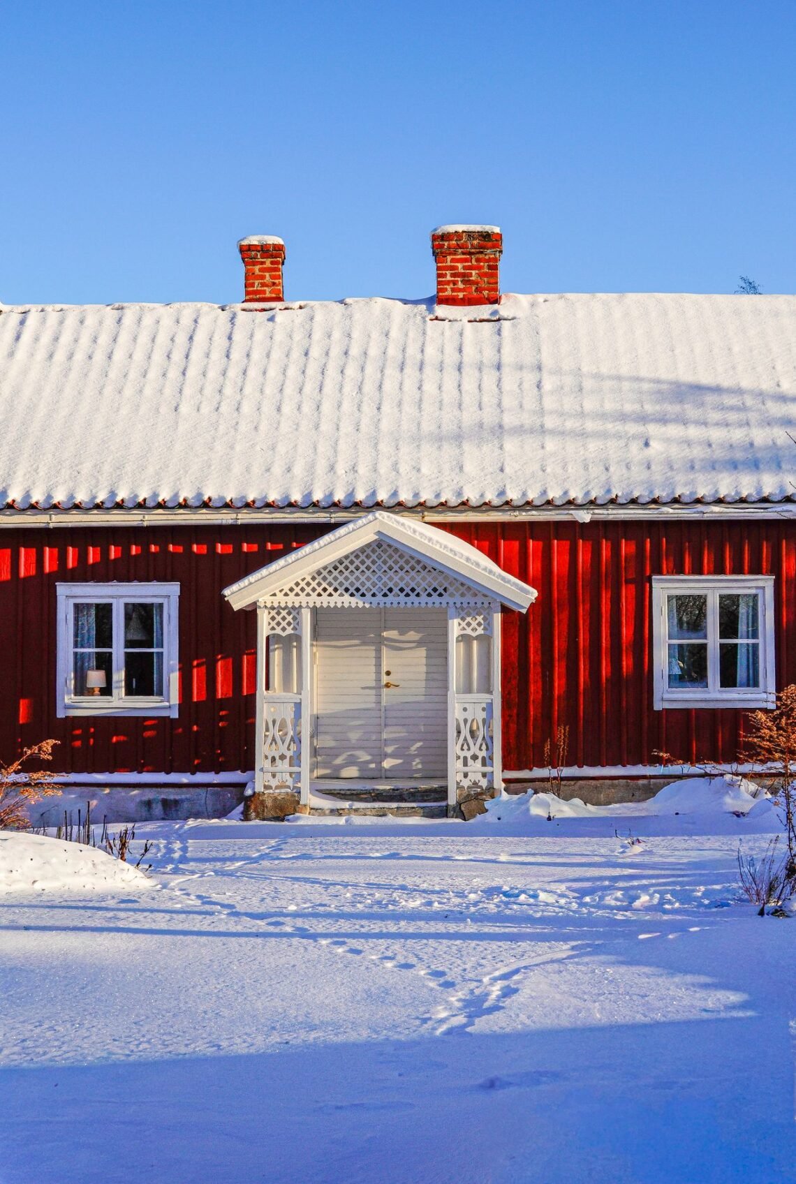 Charming red cabin in a snowy winter landscape