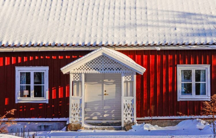 Charming red cabin in a snowy winter landscape