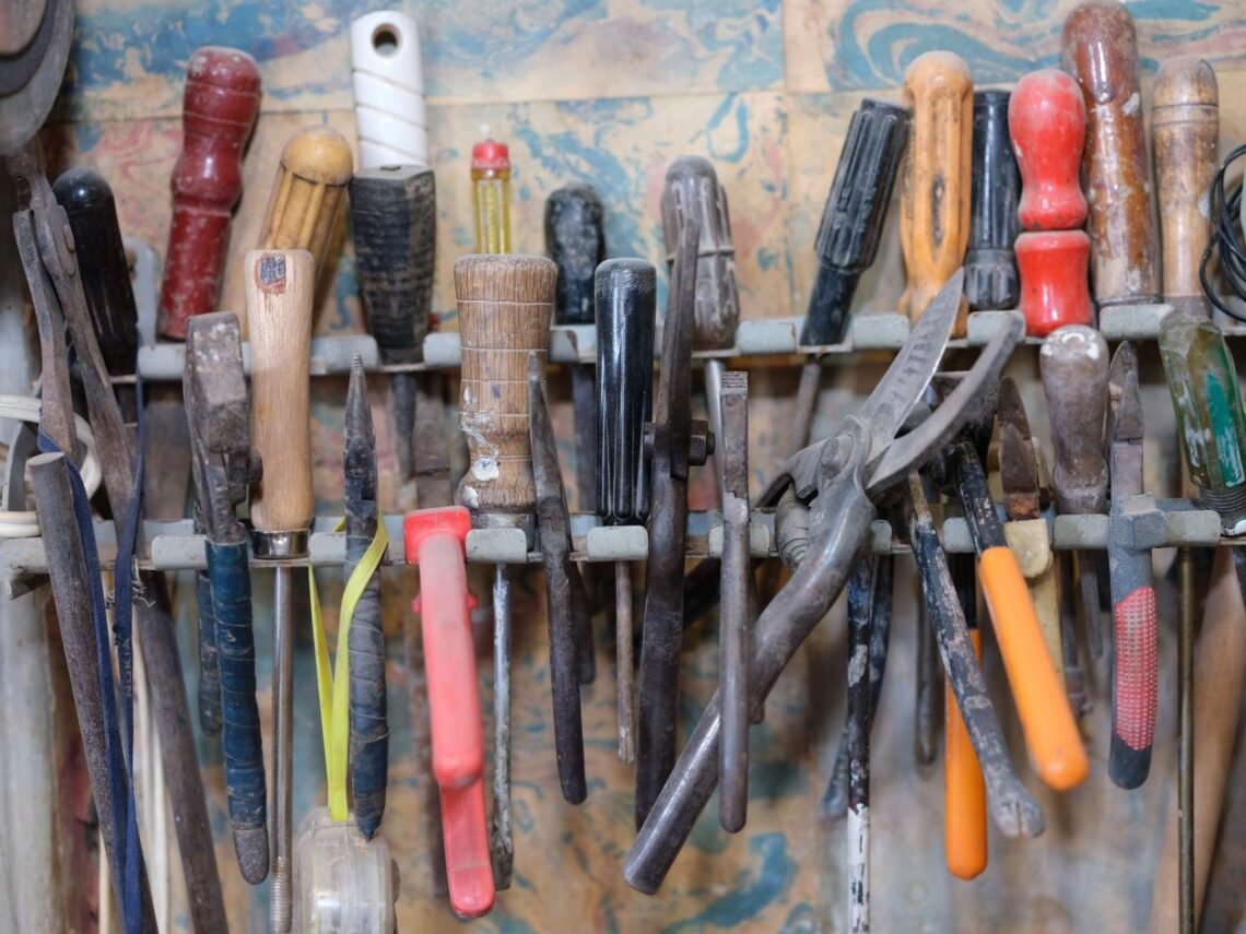 Organized tools hanging on a workshop rack