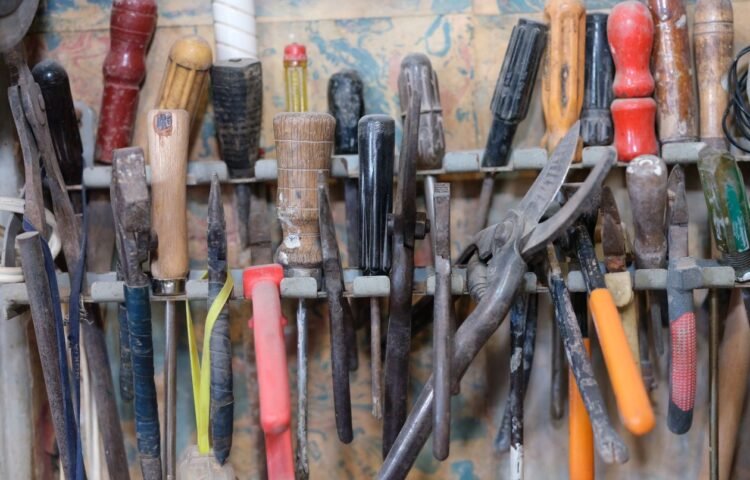 Organized tools hanging on a workshop rack